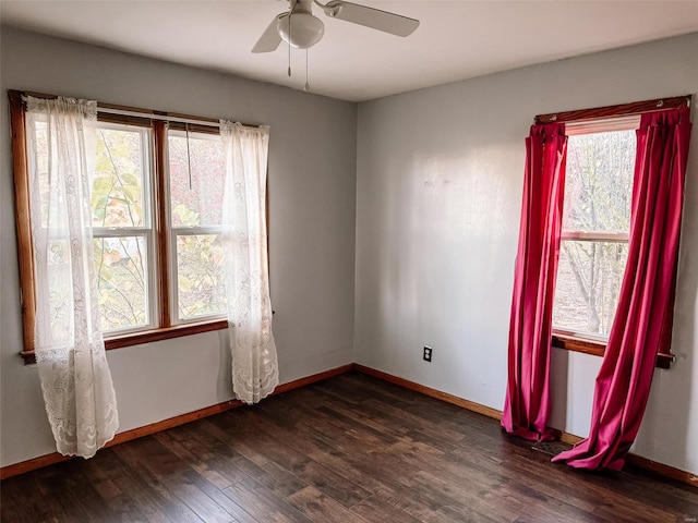 spare room featuring dark hardwood / wood-style flooring and ceiling fan