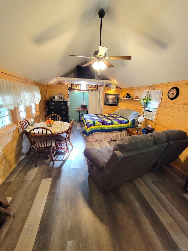 living room featuring wood walls, ceiling fan, vaulted ceiling, and dark hardwood / wood-style floors