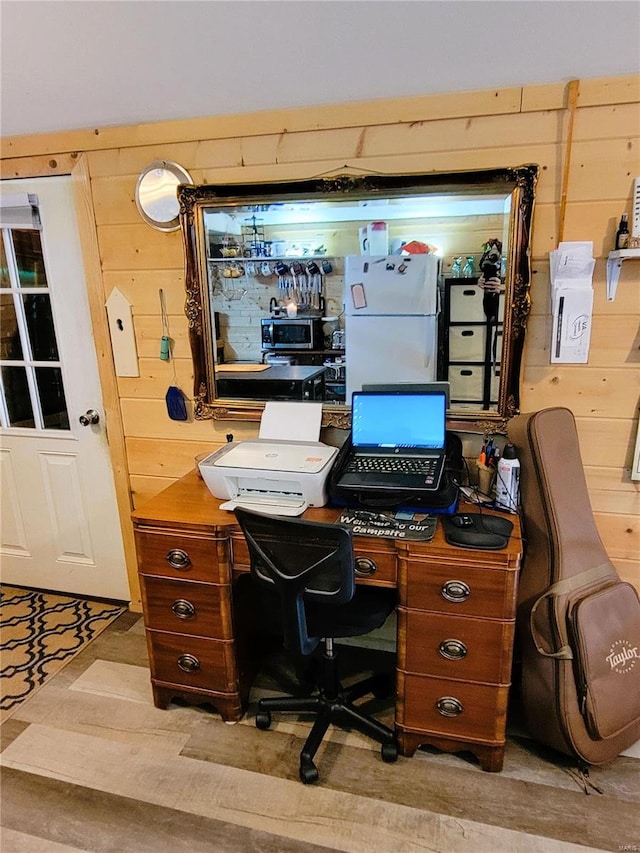 office area featuring wood walls