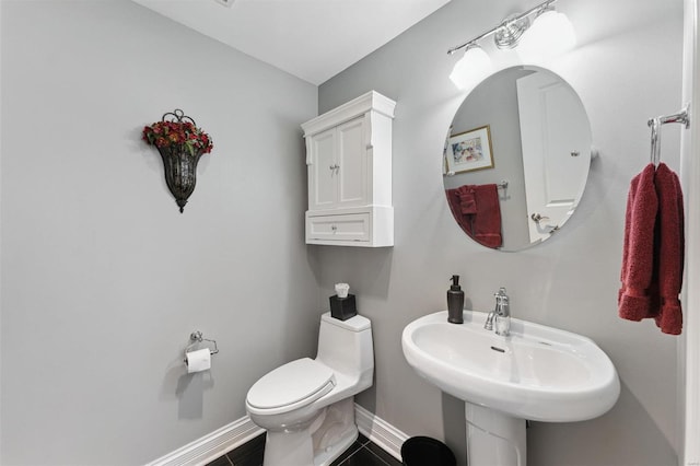 bathroom with tile patterned floors, toilet, and sink