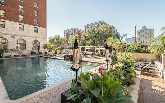 view of swimming pool featuring a patio area and pool water feature