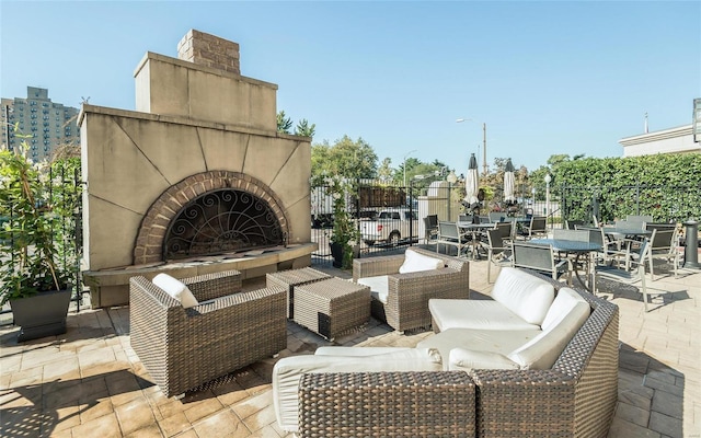 view of patio / terrace featuring an outdoor fireplace