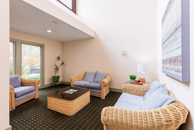 living room with dark colored carpet