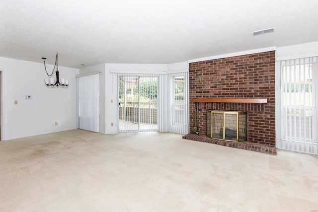 unfurnished living room featuring a textured ceiling, light colored carpet, and a brick fireplace