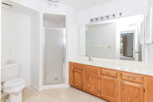 bathroom featuring vanity, toilet, and walk in shower