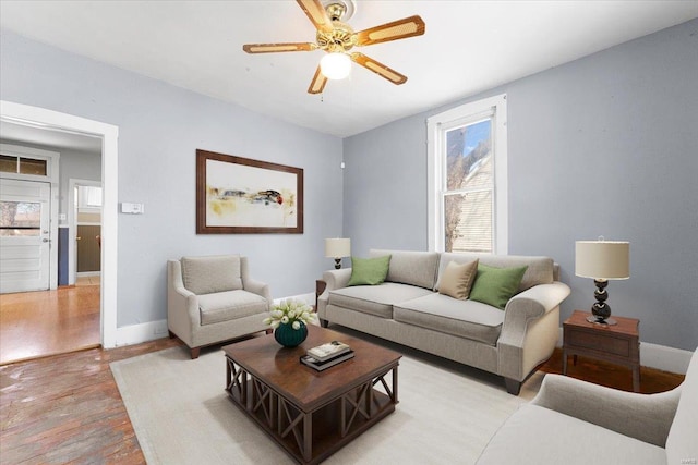 living room featuring ceiling fan and light hardwood / wood-style floors