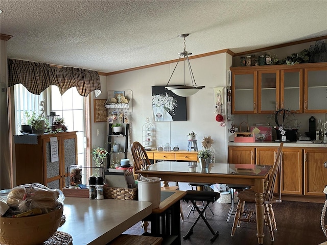 dining area with ornamental molding and a textured ceiling