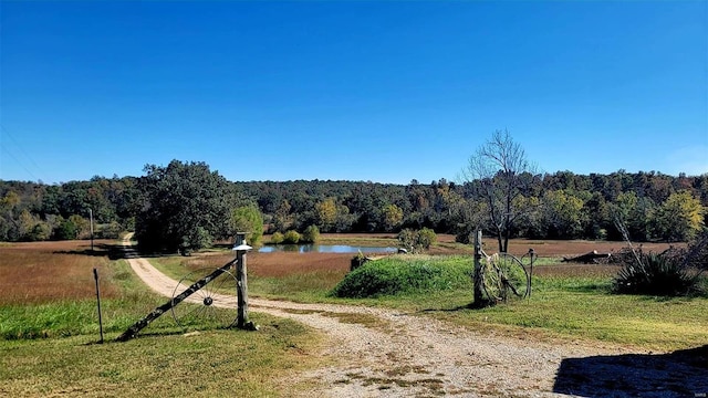 view of road featuring a rural view and a water view