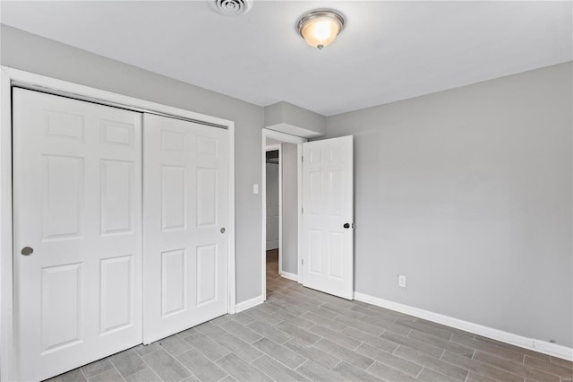 unfurnished bedroom featuring a closet and light hardwood / wood-style flooring