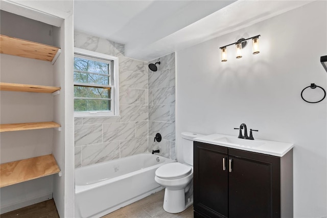 full bathroom with toilet, vanity, and tiled shower / bath