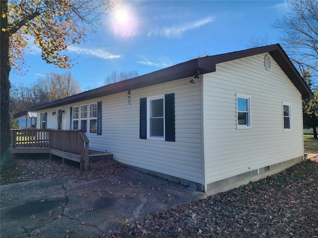 view of home's exterior with a wooden deck