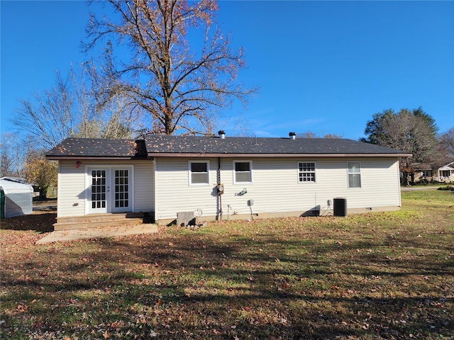 rear view of house featuring a lawn and french doors