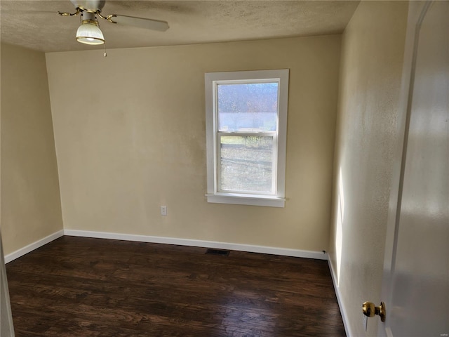 unfurnished room with ceiling fan, a textured ceiling, and dark hardwood / wood-style flooring