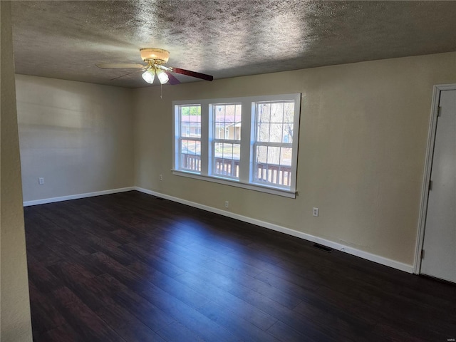 spare room with ceiling fan, a textured ceiling, and dark hardwood / wood-style floors