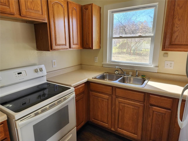 kitchen with white electric range and sink