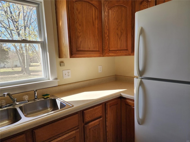 kitchen featuring sink and white fridge