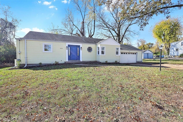 ranch-style home featuring a garage and a front lawn