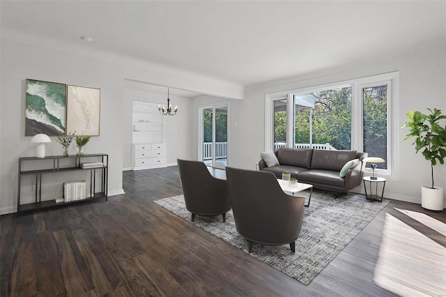 living room with radiator heating unit, dark wood-type flooring, and a chandelier