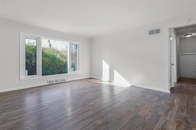 spare room with dark wood-type flooring