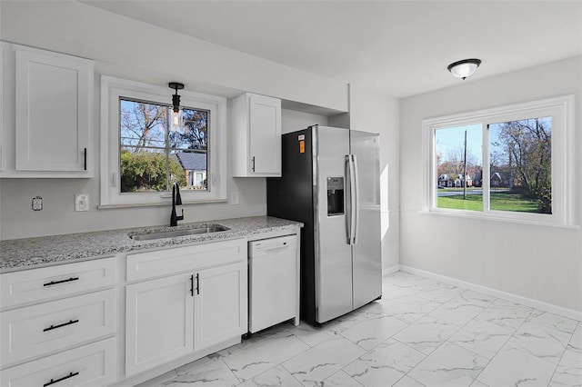 kitchen with dishwasher, white cabinetry, a wealth of natural light, and sink