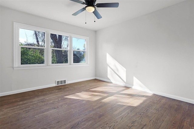 unfurnished room featuring a wealth of natural light, hardwood / wood-style floors, and ceiling fan