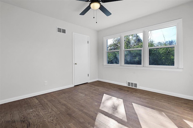 spare room featuring dark hardwood / wood-style floors and ceiling fan