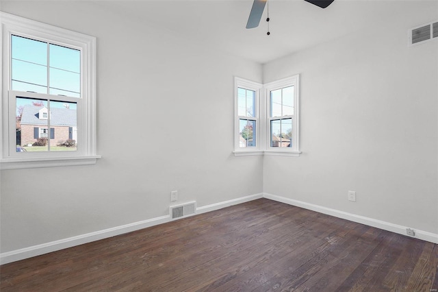 unfurnished room featuring dark hardwood / wood-style flooring, ceiling fan, and plenty of natural light