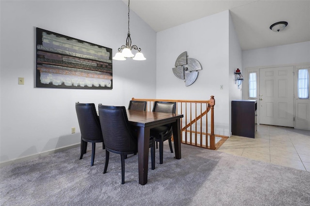 carpeted dining space featuring lofted ceiling and a chandelier