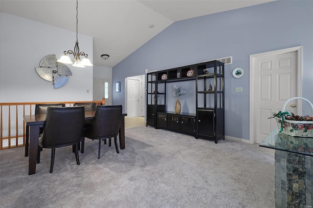 carpeted dining area featuring lofted ceiling and a notable chandelier