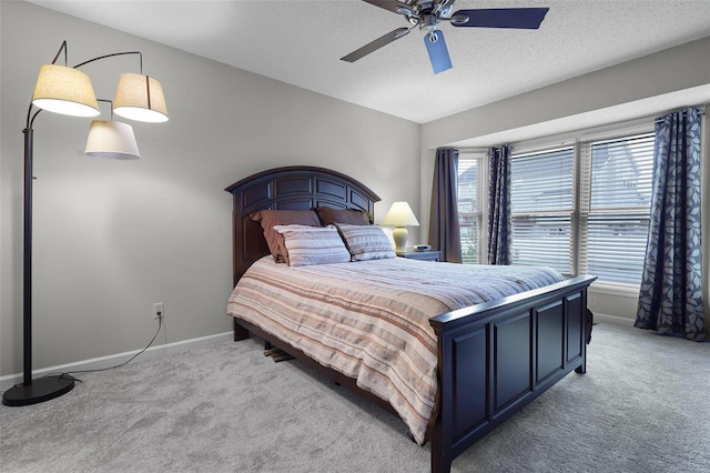 bedroom with carpet flooring, a textured ceiling, and ceiling fan