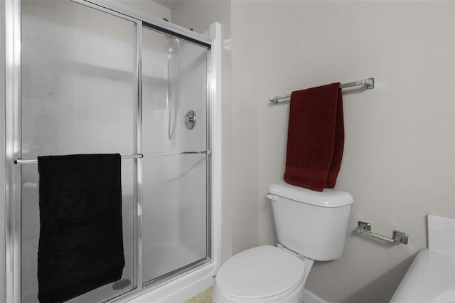 bathroom with toilet and a shower with shower door