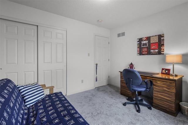 office with a textured ceiling and light colored carpet