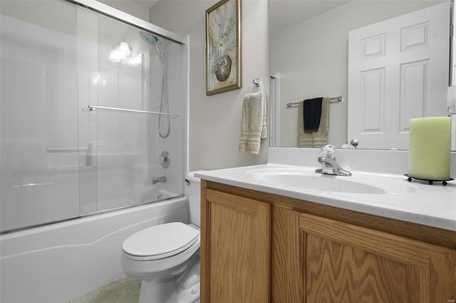 full bathroom featuring toilet, combined bath / shower with glass door, a textured ceiling, and vanity