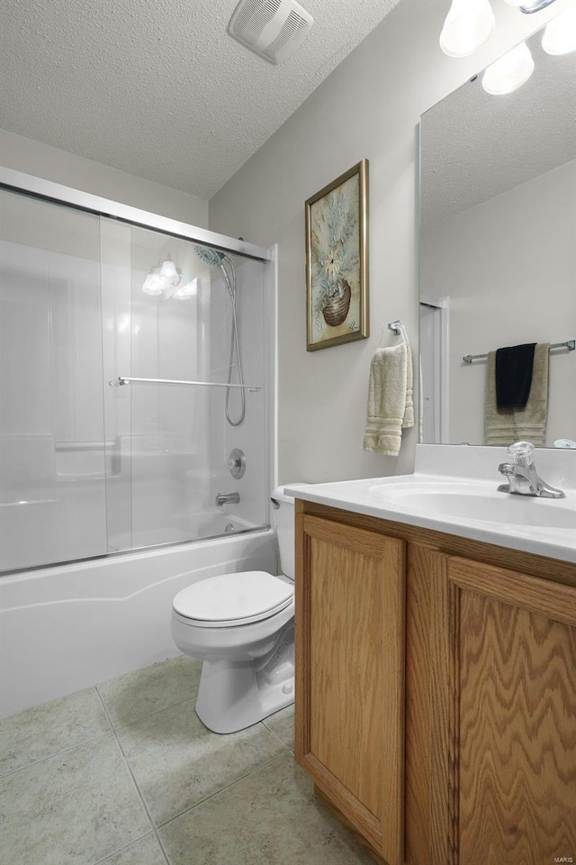 full bathroom with tile patterned flooring, bath / shower combo with glass door, a textured ceiling, toilet, and vanity