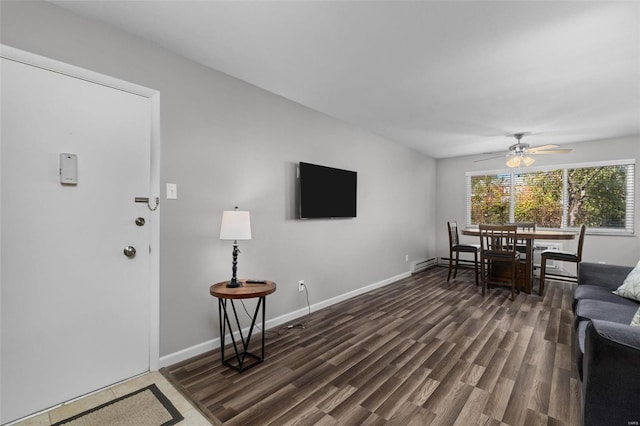 living room with ceiling fan and dark hardwood / wood-style floors