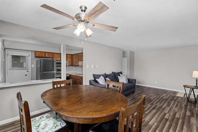 dining room with ceiling fan and dark hardwood / wood-style floors