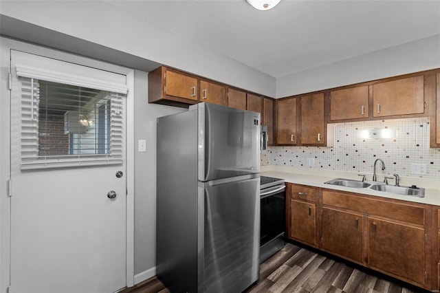 kitchen featuring dark wood-type flooring, decorative backsplash, sink, and stainless steel appliances