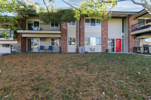 exterior space featuring a front lawn and cooling unit