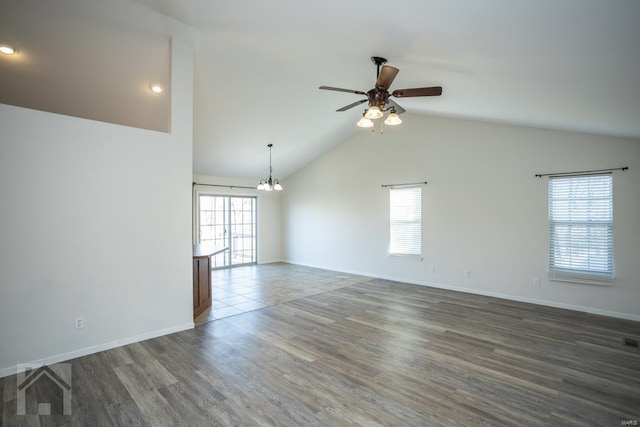 empty room featuring dark hardwood / wood-style flooring, a healthy amount of sunlight, and lofted ceiling