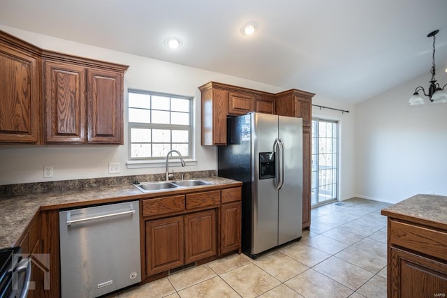 kitchen featuring a wealth of natural light, sink, vaulted ceiling, and appliances with stainless steel finishes