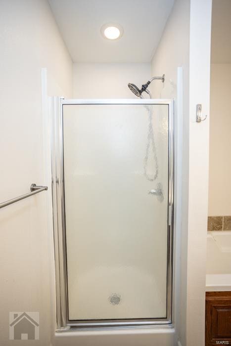 bathroom with a shower with door