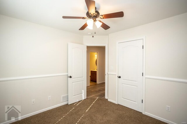 unfurnished bedroom featuring ceiling fan and dark carpet