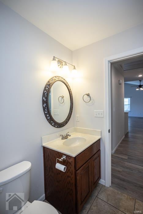 bathroom with vanity, ceiling fan, toilet, and wood-type flooring