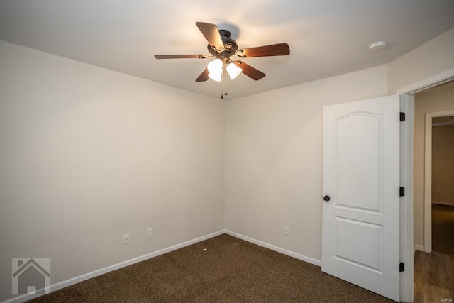 unfurnished room with ceiling fan and dark carpet