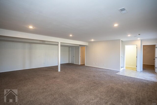 basement featuring light colored carpet