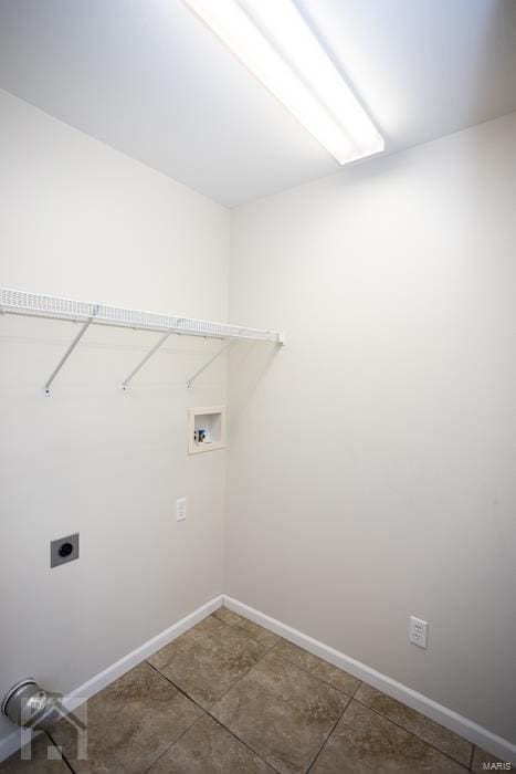 clothes washing area featuring tile patterned floors, electric dryer hookup, and hookup for a washing machine