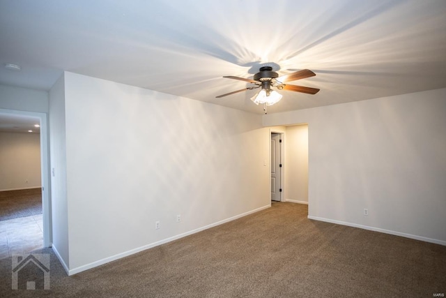 carpeted spare room with ceiling fan