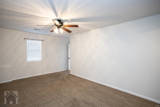 spare room featuring ceiling fan and carpet