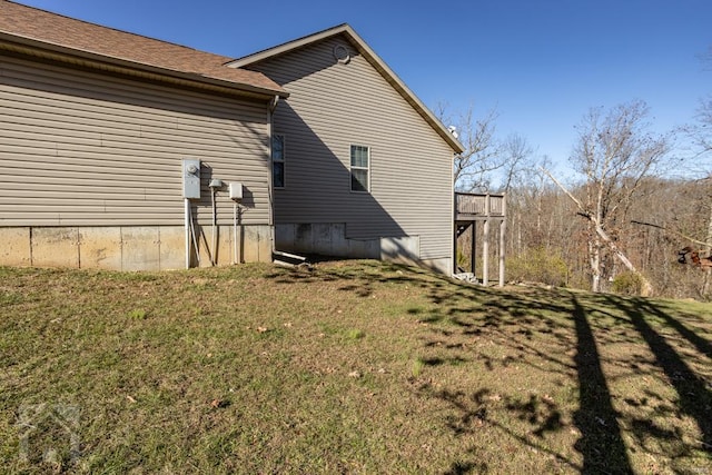 view of side of home with a yard