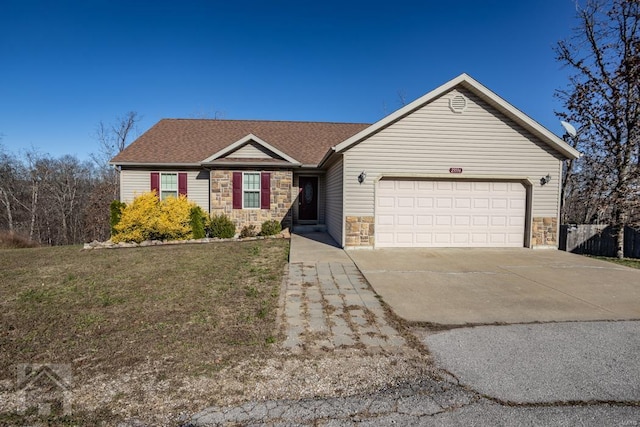 ranch-style house featuring a front yard and a garage